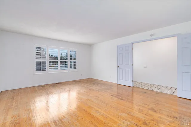 a kitchen with a refrigerator and white cabinets