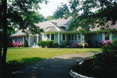 47 Cairn Ridge Road East Falmouth, MA 02536 - Photo 1 of 19 a front view of a house with a garden and porch