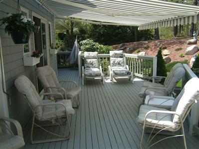 47 Cairn Ridge Road East Falmouth, MA 02536 - Photo 3 of 19 a view of a patio with table and chairs potted plants with floor to ceiling window