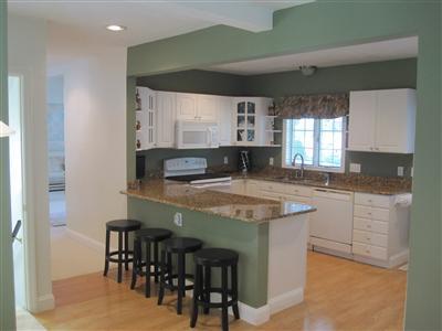 47 Cairn Ridge Road East Falmouth, MA 02536 - Photo 4 of 19 a kitchen with stainless steel appliances granite countertop table chairs sink and cabinets