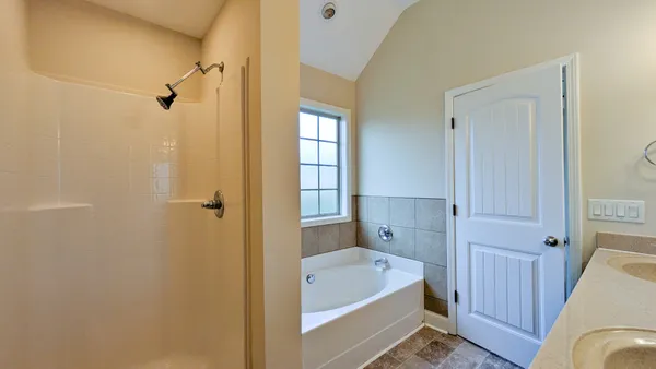 a bathroom with a tub shower and sink
