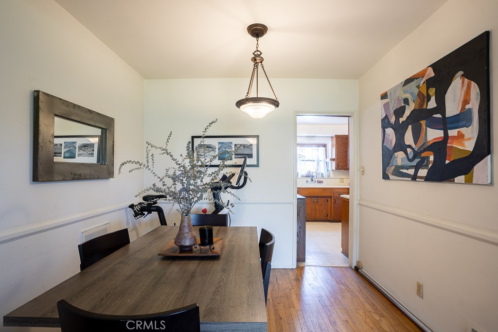 3735 Arbolada Road Los Angeles, CA 90027 - Photo 13 of 61 a view of a dining room with furniture and wooden floor