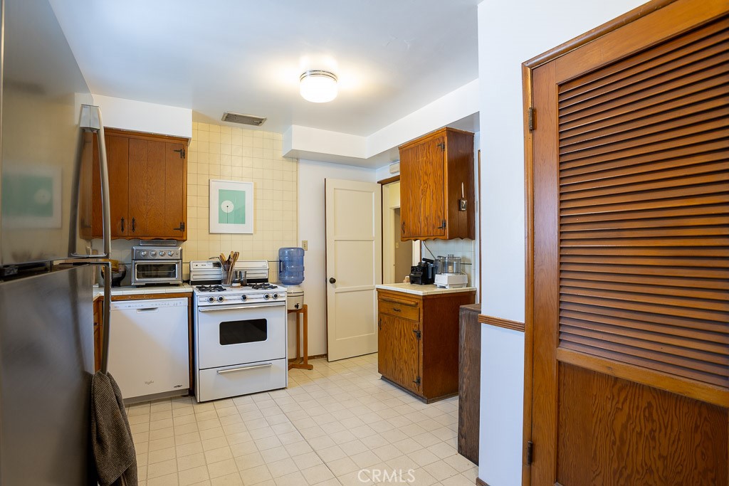 3735 Arbolada Road Los Angeles, CA 90027 - Photo 16 of 61 a kitchen with stainless steel appliances granite countertop a stove a sink and a refrigerator