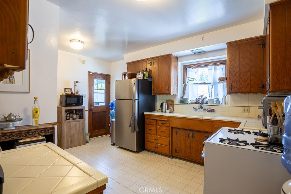 3735 Arbolada Road Los Angeles, CA 90027 - Photo 18 of 61 a kitchen with a refrigerator stove and sink