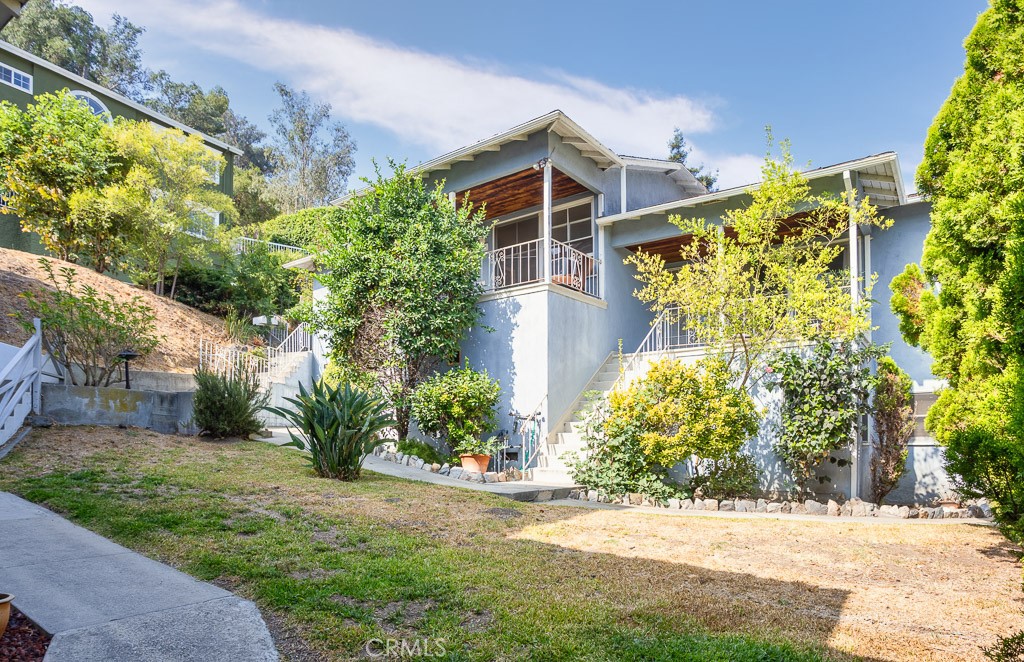 3735 Arbolada Road Los Angeles, CA 90027 - Photo 2 of 61 front view of a house with a yard and potted plants