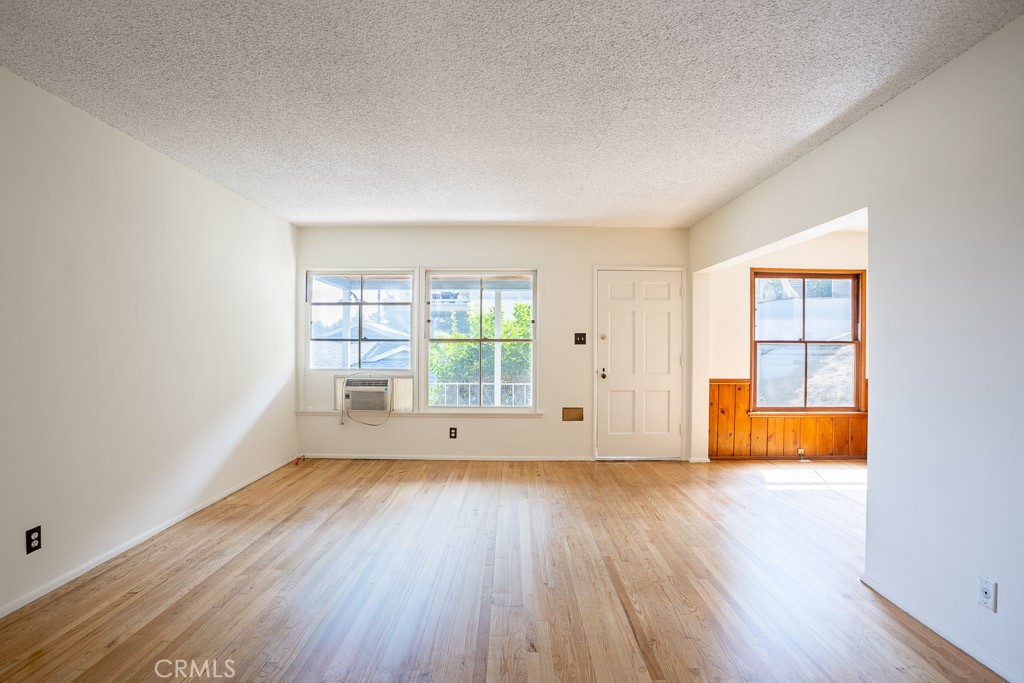 3735 Arbolada Road Los Angeles, CA 90027 - Photo 32 of 61 an empty room with wooden floor and windows