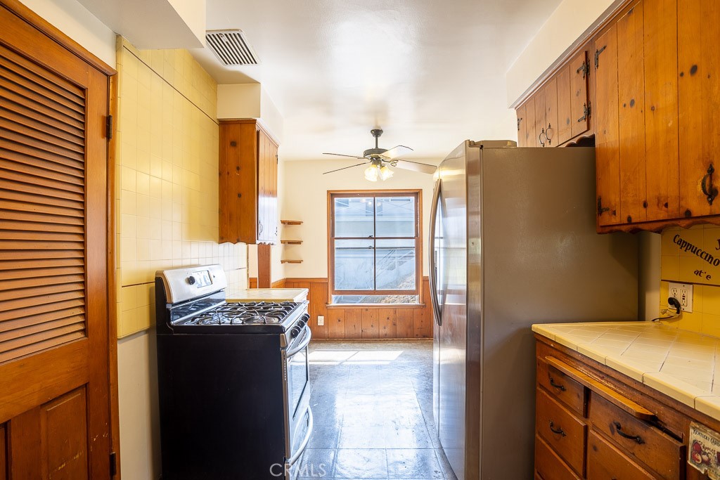3735 Arbolada Road Los Angeles, CA 90027 - Photo 39 of 61 a bathroom with a granite countertop sink and a mirror