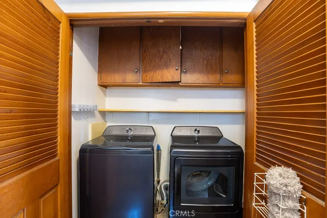 an empty room with a window and wooden floor