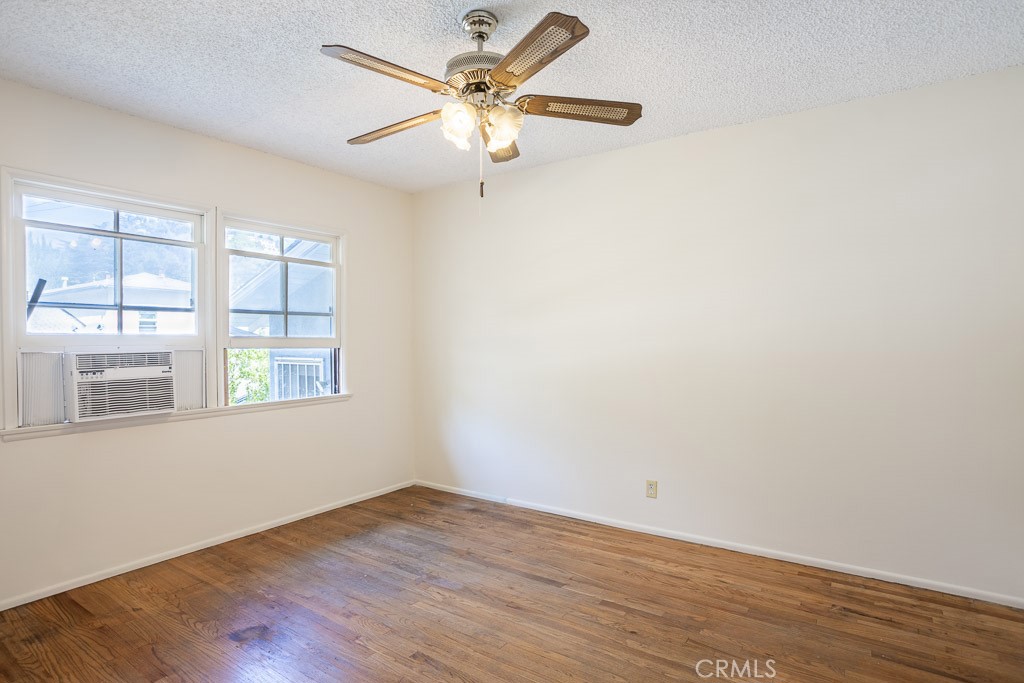 3735 Arbolada Road Los Angeles, CA 90027 - Photo 47 of 61 an empty room with wooden floor fan and windows
