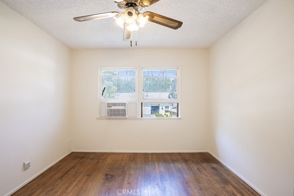 3735 Arbolada Road Los Angeles, CA 90027 - Photo 48 of 61 an empty room with a window and wooden floor
