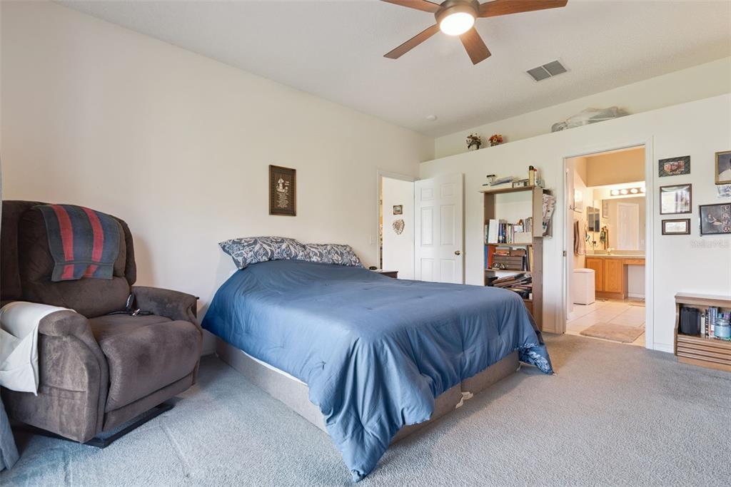 1209 Castleport Road Winter Garden, FL 34787 - Photo 17 of 36 a spacious bedroom with a bed and a couch