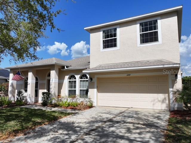 1209 Castleport Road Winter Garden, FL 34787 - Photo 2 of 36 a front view of a house with garden