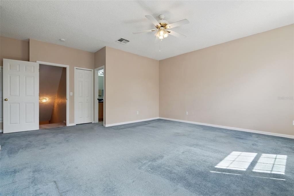 1209 Castleport Road Winter Garden, FL 34787 - Photo 21 of 36 an empty room with a chandelier fan and windows