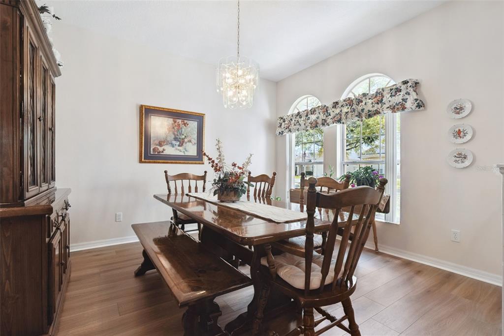 1209 Castleport Road Winter Garden, FL 34787 - Photo 5 of 36 a view of a dining room with furniture a chandelier and wooden floor