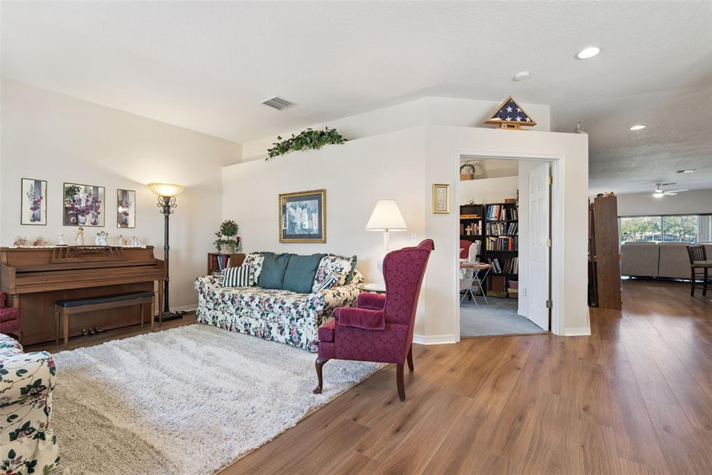 1209 Castleport Road Winter Garden, FL 34787 - Photo 7 of 36 a living room with furniture and wooden floor
