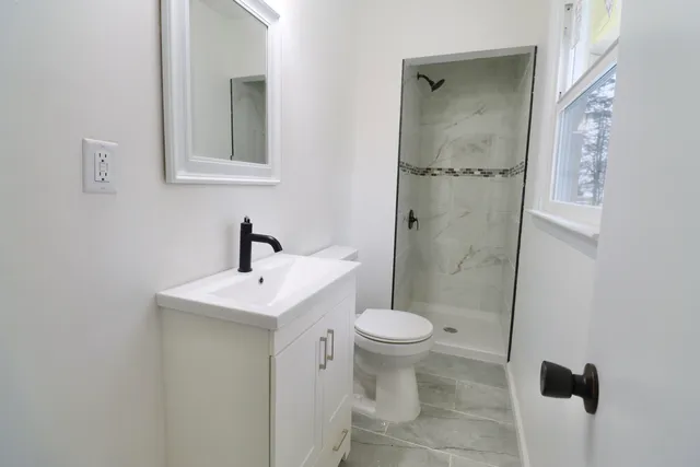 a bathroom with a sink toilet and shower