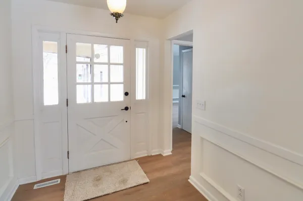a view of a kitchen with a sink and dishwasher wooden floor