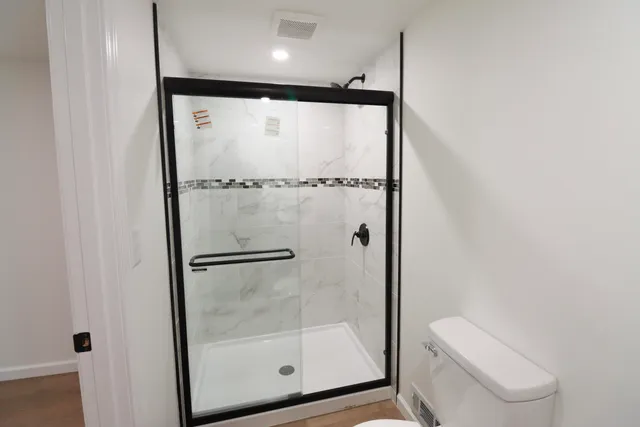 a bathroom with a glass shower door