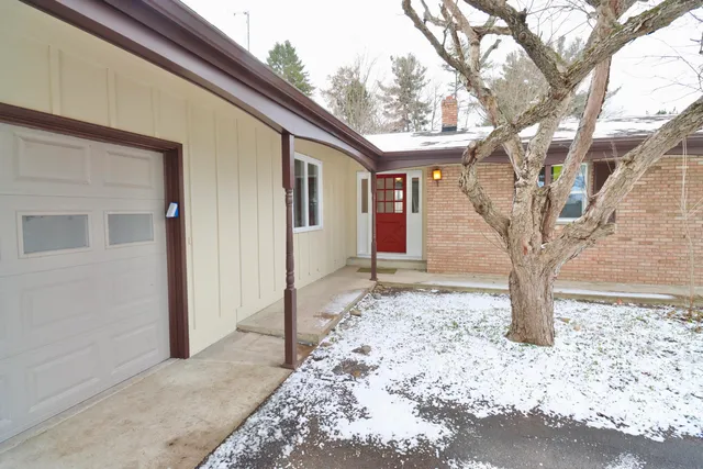 a view of a house with a yard covered in snow