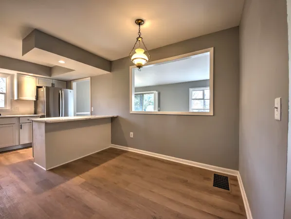 a view of a kitchen with a sink and cabinets