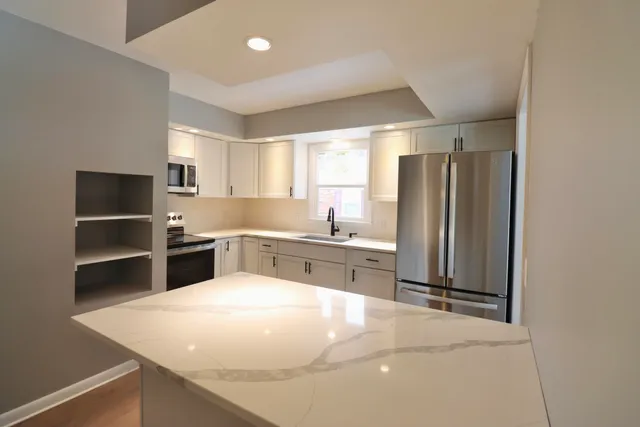 a kitchen with stainless steel appliances a refrigerator and a sink