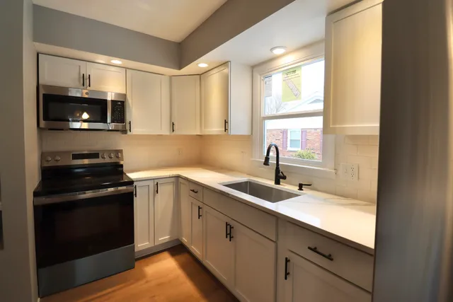 a kitchen with a sink stove and microwave