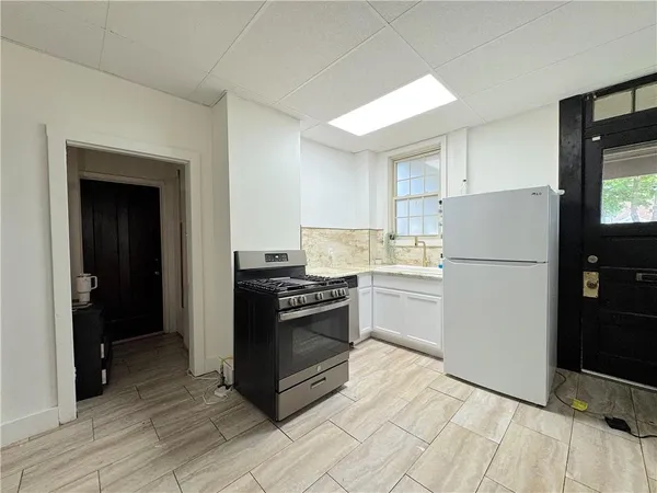 a kitchen with a refrigerator stove and cabinets