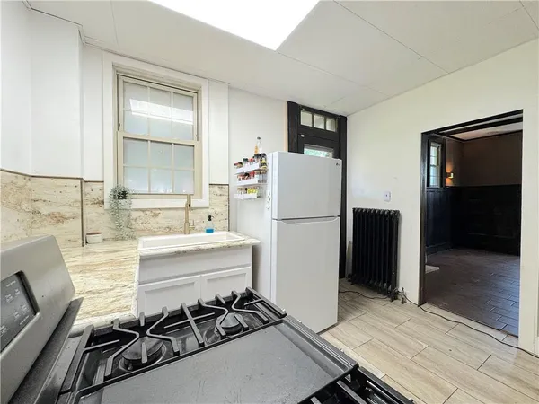 a kitchen with a refrigerator and a stove top oven