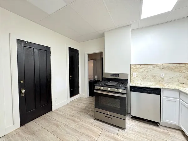 a kitchen with a stove and a refrigerator