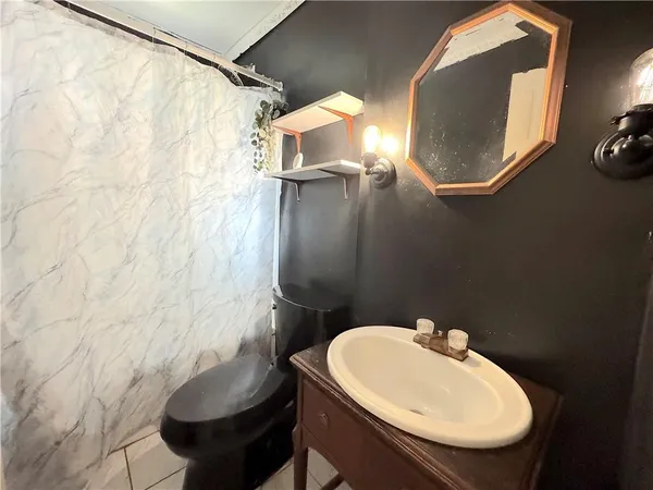 a bathroom with a sink toilet and mirror