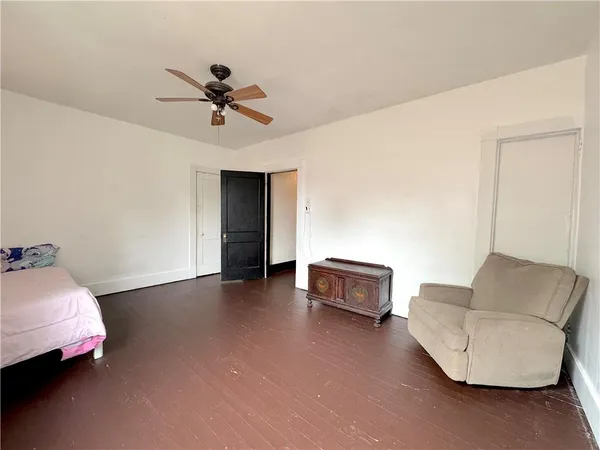 a living room with furniture and a ceiling fan