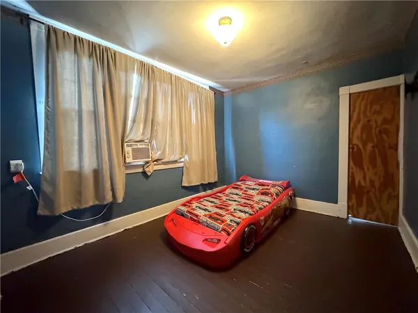 a bedroom with a bed and a window