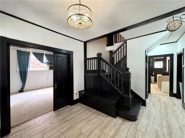 a view of a hallway with wooden floor and staircase