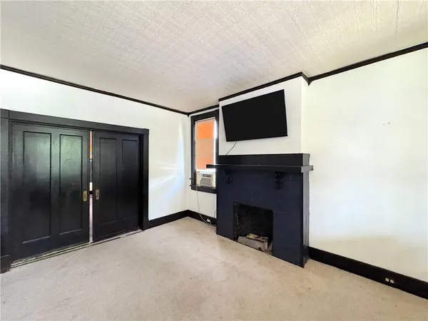 a view of an empty room with a fireplace