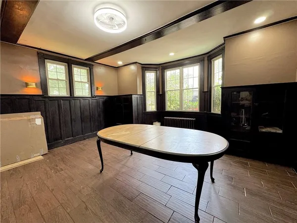 a view of a room with a table and chairs