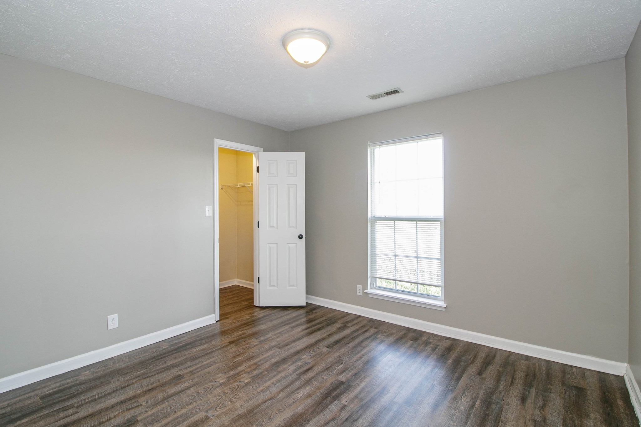 947 State Line Road Oak Grove, KY 42262 - Photo 12 of 25 an empty room with wooden floor and windows