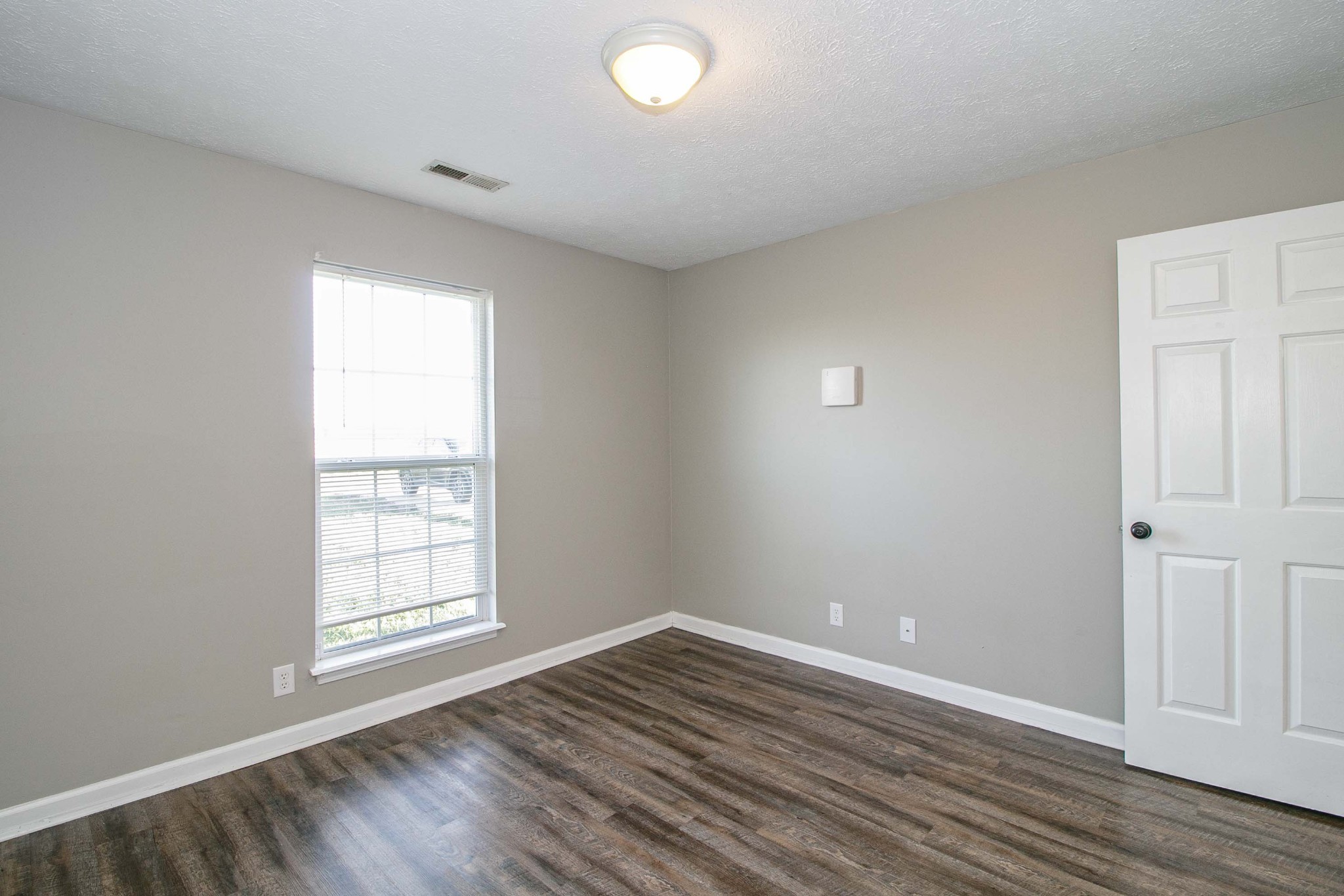 947 State Line Road Oak Grove, KY 42262 - Photo 15 of 25 an empty room with wooden floor and windows