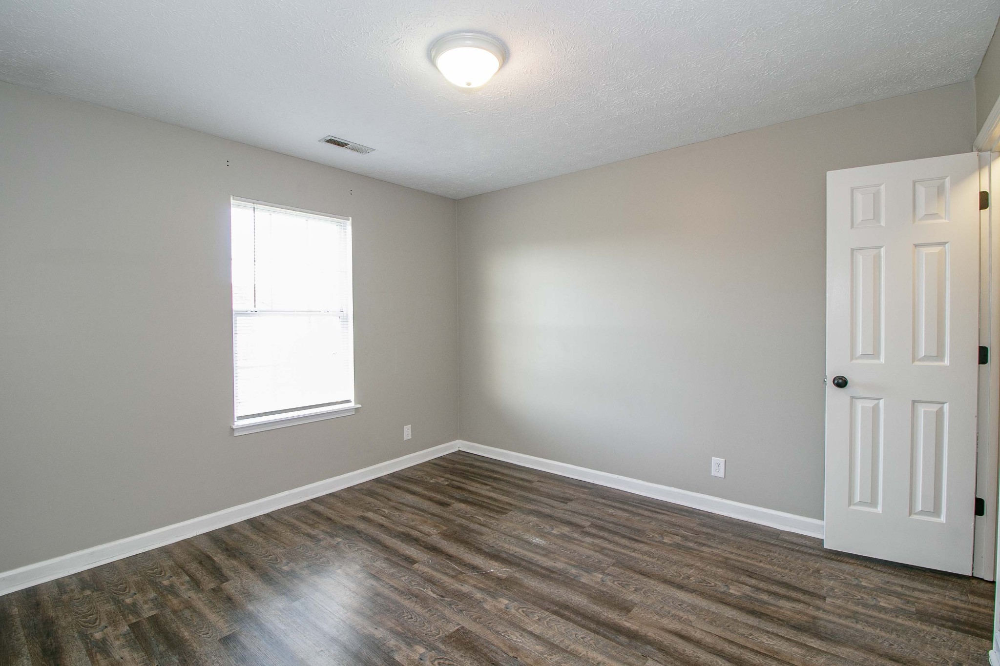 947 State Line Road Oak Grove, KY 42262 - Photo 16 of 25 an empty room with wooden floor and windows
