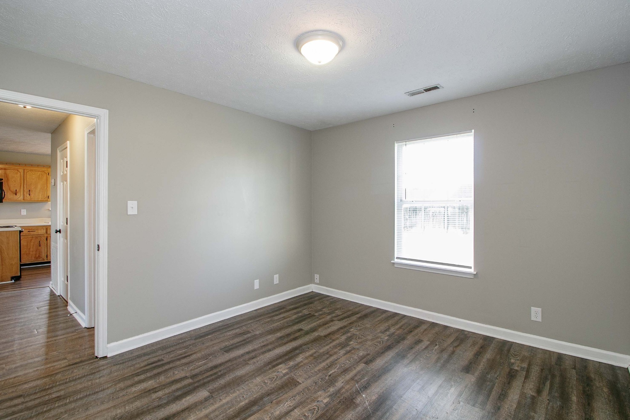 947 State Line Road Oak Grove, KY 42262 - Photo 17 of 25 an empty room with wooden floor and windows