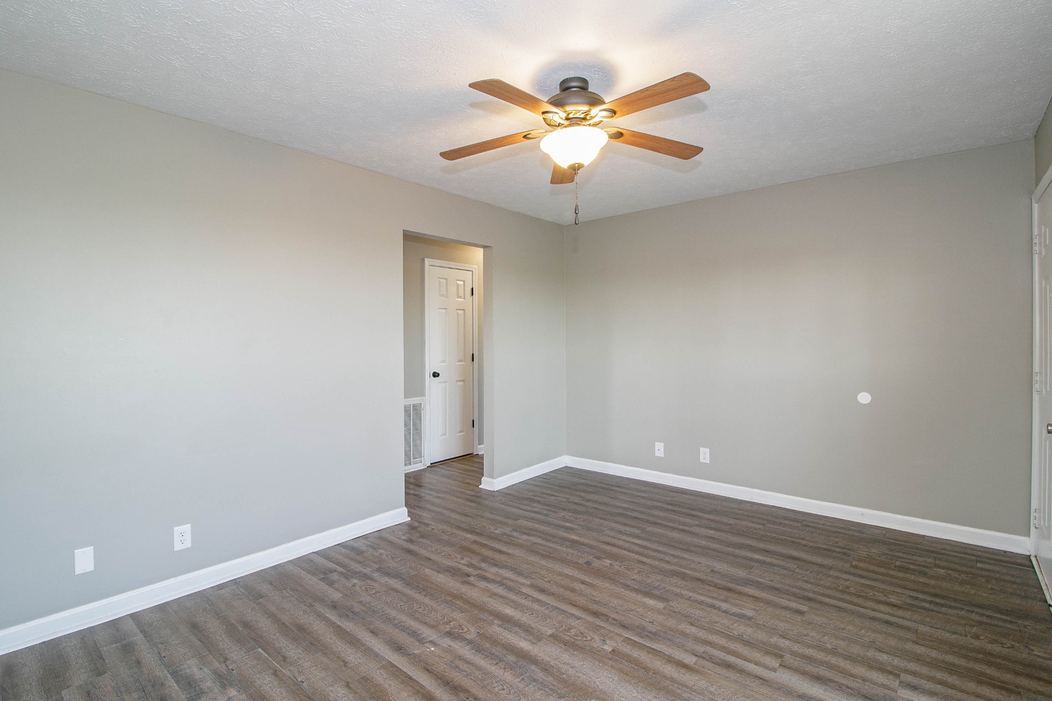 947 State Line Road Oak Grove, KY 42262 - Photo 3 of 25 an empty room with wooden floor and fan