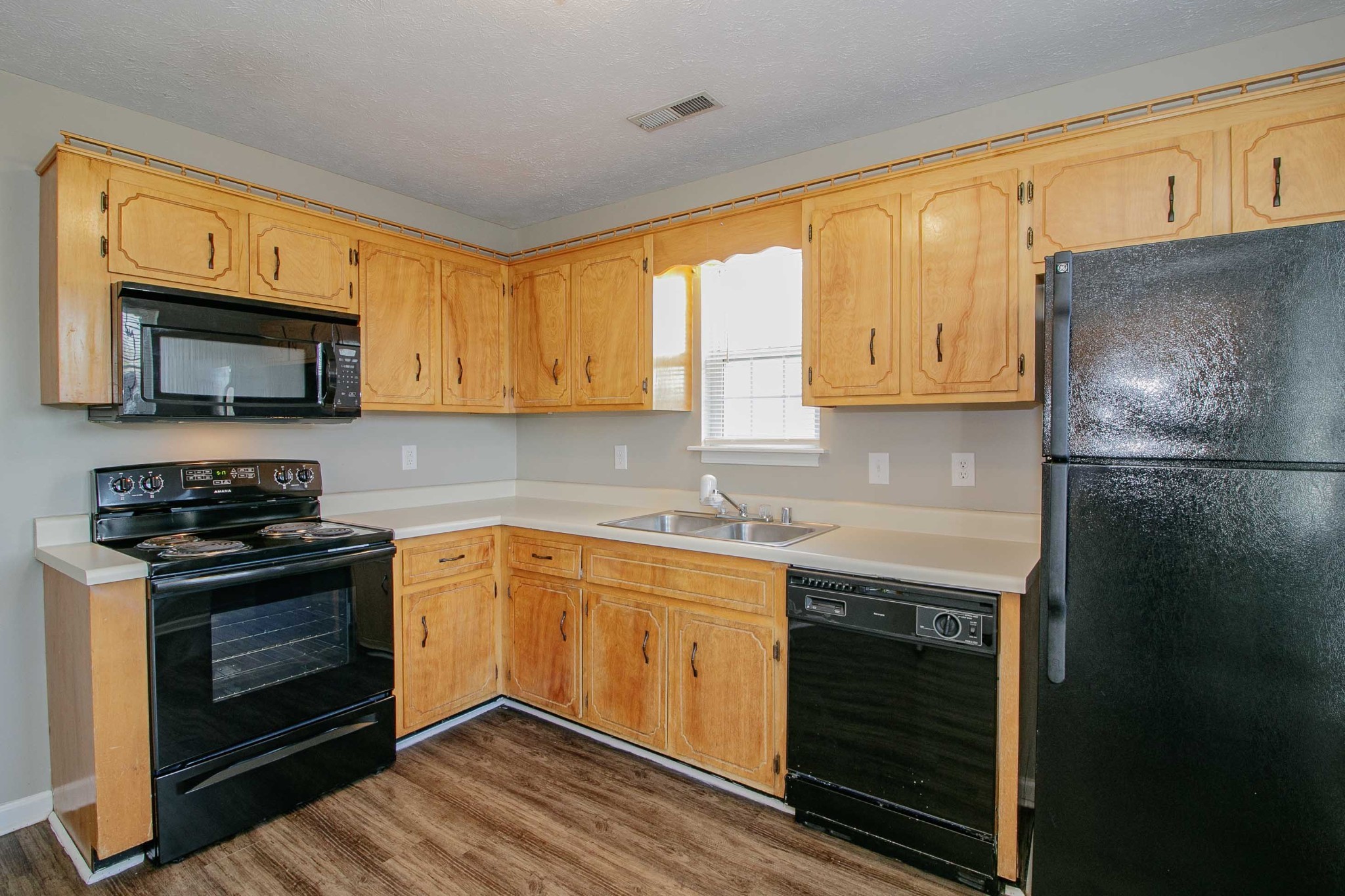 947 State Line Road Oak Grove, KY 42262 - Photo 8 of 25 a kitchen with stainless steel appliances granite countertop a stove microwave sink and refrigerator