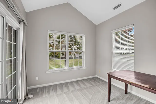 a view of a room with furniture and a window