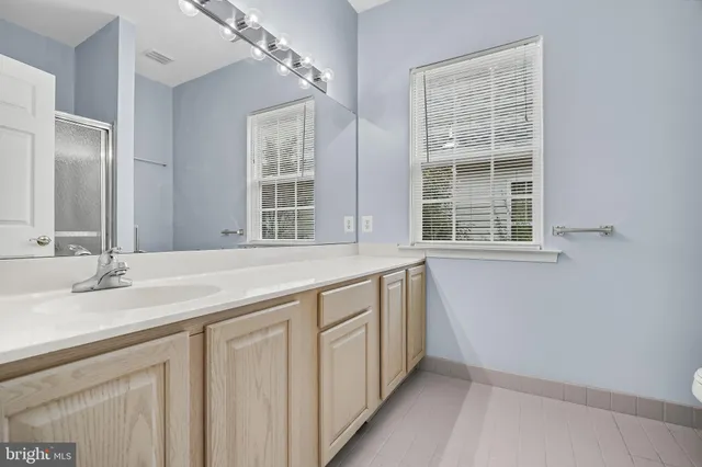 a bathroom with a sink and a window