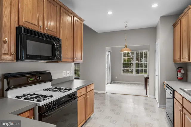 a kitchen with stainless steel appliances a stove a microwave and sink