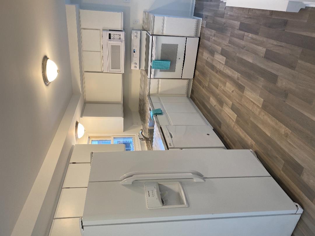14 Rogers Farm Road Vineyard Haven, MA 02568 - Photo 2 of 12 a kitchen with a sink stove and refrigerator