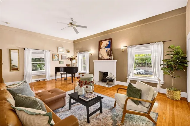 a living room with furniture a fireplace and a large window