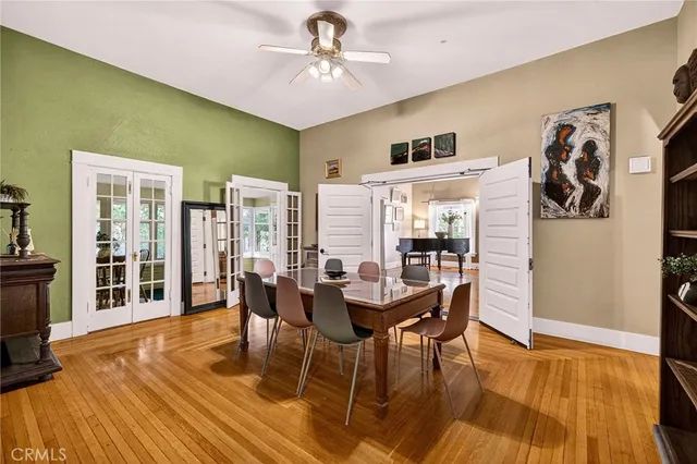 a dining room with furniture entryway and wooden floor