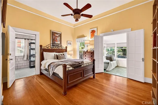 a bedroom with a bed and wooden floor