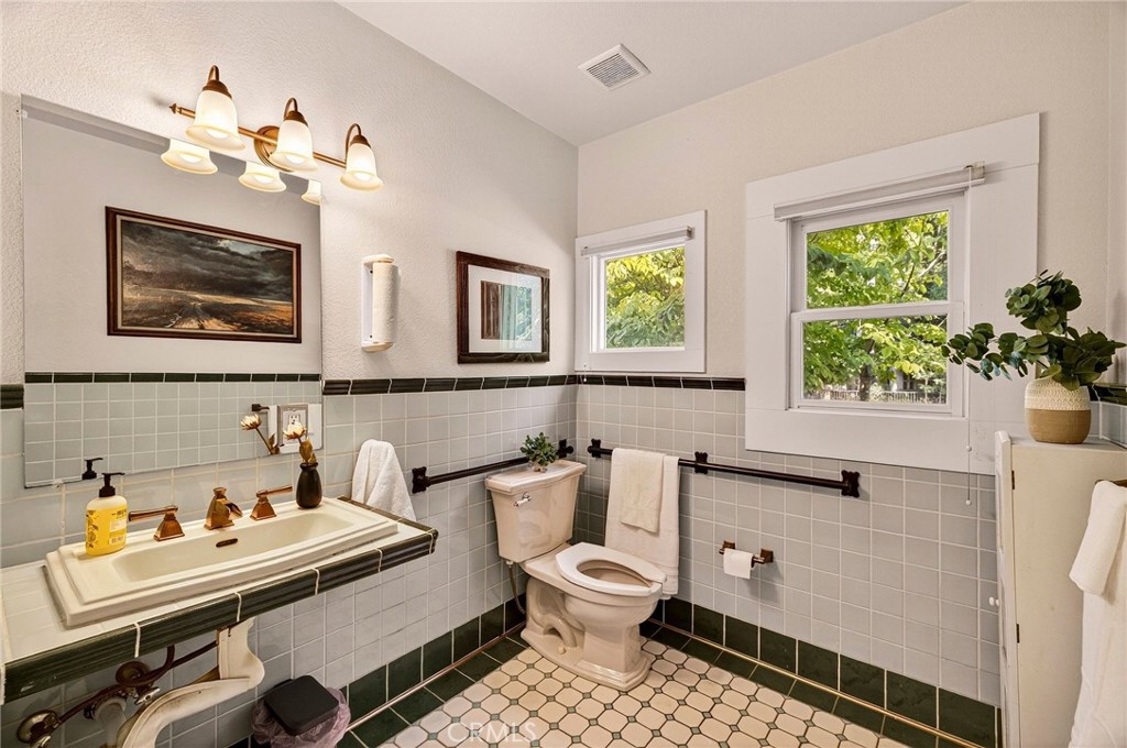 1050 Esplanade Chico, CA 95926 - Photo 25 of 42 a bathroom with a sink a mirror and a toilet