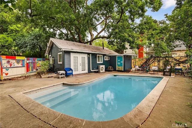 a view of a house with swimming pool and sitting area